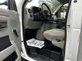 Interior view of a 2017 Ford Econoline showing the driver's seat and dashboard with a mat that says Thank You for Your Business