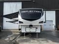 A 2021 Grand Design Recreational 311BHS travel trailer with a sleek design and prominent "Reflection" branding on the front