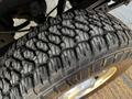 Close-up of a tire from a 2012 Ford F-250 showcasing detailed tread patterns and texture on the rubber surface