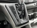 Gear shift lever of a 2021 Ford Transit featuring positions for park reverse neutral drive and manual