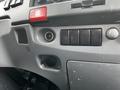 Interior dashboard controls of a 2018 Isuzu NRR featuring switches and outlets for various functions