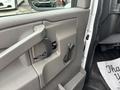 Interior door handle and controls of a 2020 Chevrolet Express van showcasing a gray door panel design