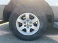 A close-up of a silver alloy wheel with a Goodyear tire on a 2013 Ford Expedition