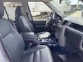 Interior of a 2006 Land Rover LR3 featuring leather seats and a center console with cup holders and controls