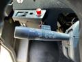 A close-up of a vehicle's turn signal and wiper control stalk featuring various settings labeled for delay, off, low, and high functions