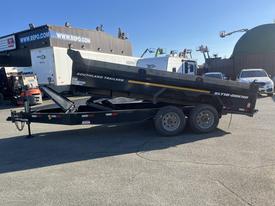 2024 Southland 18 foot dump trailer with a black exterior and a hydraulic lift mechanism for unloading materials