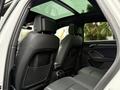Interior view of a 2024 Audi Q3 showing black leather rear seats with headrests and storage pockets on the backrest