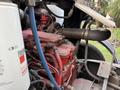 A red engine from a 2010 Autocar Xpeditor with visible pipes wires and components