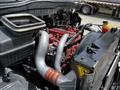 A close-up view of the engine compartment of a 2019 International 4300 showcasing various engine components including hoses pipes and a coolant reservoir