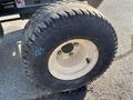 Close-up of a Kubota F3990 tire showing a worn tread pattern and a white rim with bolts visible