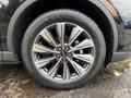 Close-up of a silver alloy wheel with a black tire featuring the Lincoln logo and intricate spoke design on a 2020 Lincoln Corsair