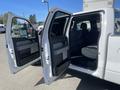 A 2012 Ford F-150 with both front doors open revealing the spacious interior and seating area