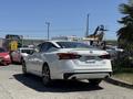 A white 2021 Nissan Altima parked with its rear view visible showcasing sleek lines and modern design features