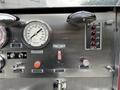 Control panel of a 1991 Sutphen Deluge featuring gauges buttons and indicators for water level tank fill and air horn