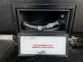 A black compartment door open to reveal fuel dispensing hoses and a control panel with an emergency shutoff switch for a 2022 Heartland Torque