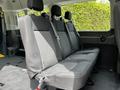 Interior view of a 2022 Ford Transit showing the back row of black fabric seats with seat belts