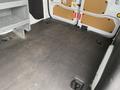 Interior view of a 2017 Ford Transit Connect cargo area featuring a dark floor and mounted tie-down points