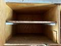 an empty wooden storage compartment with two wooden shelves inside