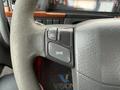 Close-up of the steering wheel of a 2012 Volvo VNL showing controls for turn signals and hazard lights