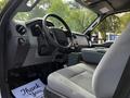 Interior view of a 2016 Ford F-550 showing the dashboard steering wheel and front seat with a thank you mat on the floor