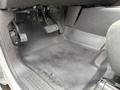 Interior view focusing on the driver's side floor of a 2013 Chevrolet Silverado 3500HD showing pedals and textured rubber flooring