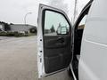 A 2014 GMC Savana van with its driver's side door open showing the interior door panel and handle