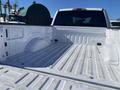 A white 2019 Ford F-150 truck bed showing the interior design with a smooth floor and side walls without any cargo