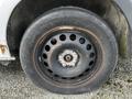 A close-up view of a black steel wheel from a 2018 Mercedes-Benz Metris featuring multiple circular cutouts and a rusty finish