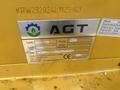 A metal identification plate on a yellow mini loader displaying the AGT logo model information and specifications including type KRW 23 owner and load capacity