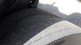 Close-up of two large, worn tires on a 2012 International DuraStar 4300 showing visible tread wear and sidewall detail