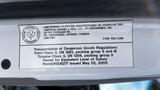 A 2006 Ford LCF 550 with a safety compliance label detailing dangerous goods transportation regulations