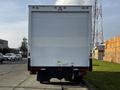 A 2015 Hino 195 box truck viewed from the rear with a plain white exterior and a cargo loading area visible