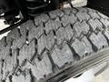 Close-up of a heavily treaded tire from a 2007 Ford F-550 showcasing deep grooves and textured surface for traction