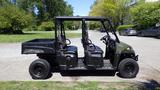 A 2016 Polaris Ranger 570 Crew vehicle with four seats and a cargo bed, featuring a black exterior and rugged tires