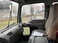 Interior view of a 2006 GMC F7B042 truck showing the driver's seat and dashboard with documents placed on the seat