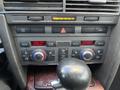 The dashboard controls of a 2006 Audi A6 featuring temperature knobs and buttons for various climate settings