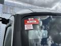 A 2018 Hino 195 with a red and white certificate of approval sticker affixed to the windshield displaying the year 2026 and the months January February and March
