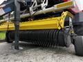 A 2020 Pottinger Impress featuring a yellow and black rotary cutting mechanism with sharp metal tines for harvesting forage crops.