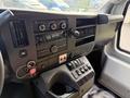 Interior dashboard of a 2020 Chevrolet Express featuring audio controls climate settings and various buttons for vehicle functions