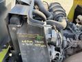 2010 Kubota F3990 tractor engine with visible components including air intake and markings for maintenance instructions