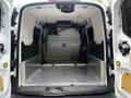 Interior view of a 2016 Ford Transit Connect cargo van showing a spacious empty cargo area with a metal floor and side panels