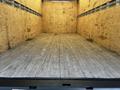A 2020 Hino 155 box truck with a spacious empty cargo area featuring wooden walls and a wooden floor