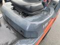 A blue and orange 2011 Toyota forklift model 028FG15 with a black seat and control levers visible on the top