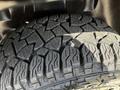 Close-up of a rugged tire with a deep tread pattern designed for off-road performance on a 2019 RAM 1500