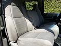 A gray fabric interior of a 2008 Ford F-550 featuring two spacious front seats with seatbelts and textured upholstery