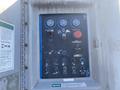 Control panel of a 1997 Genie S-65 4X4 featuring gauges switches and buttons for operating the equipment