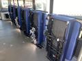 Several blue foldable seats are neatly arranged in rows, secured to the floor of a vehicle interior