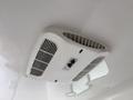 An overhead air conditioning unit with a rectangular design and multiple vents for airflow in a 2025 Shuttle Office