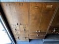 A wooden storage unit with multiple drawers and compartments featuring metal handles and label slots on the front