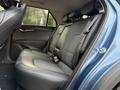 The interior of a 2023 Kia Niro EV featuring a spacious back seat with black leather upholstery and two headrests